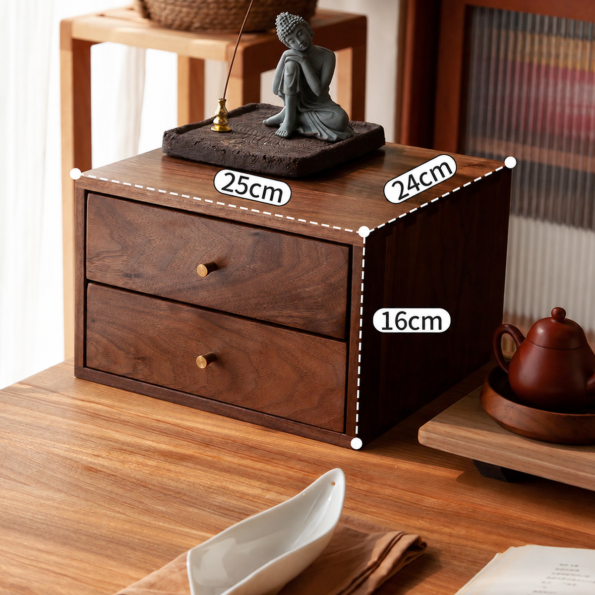 A dark brown wooden two-drawer organizer box with dimension labels showing 25cm width, 24cm depth, and 16cm height, placed on a wooden table in a styled room setting.