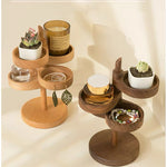 Two wooden jewelry organizers with multiple tiers, styled with small succulent plants, a candle, a perfume bottle, and jewelry, set against a warm beige background with soft shadows.