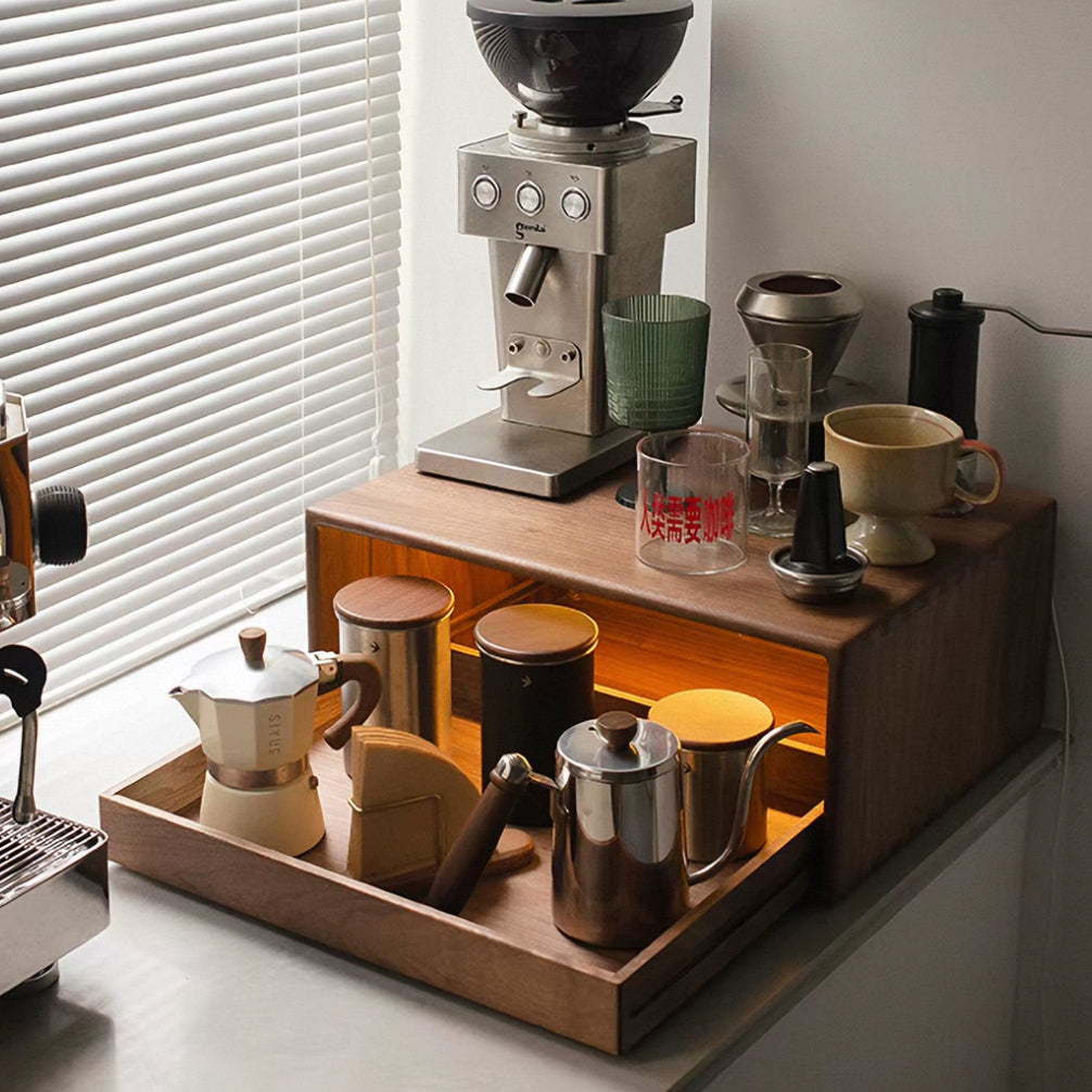 A wooden coffee station shelf with a pull-out lower drawer, styled with coffee gear including a grinder, mugs, canisters, and a small kettle on a kitchen counter.