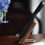 Lean back wooden phone holder made from natural walnut wood