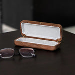 Minimalist walnut glasses case with smooth wood grain finish
