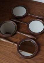 Natural wood handheld mirror with smooth walnut grain finish