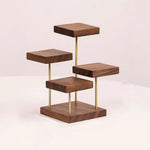 A modern four-tier wooden shelf stand with a dark walnut finish and slim gold metal support rods, shown on a clean off-white background.