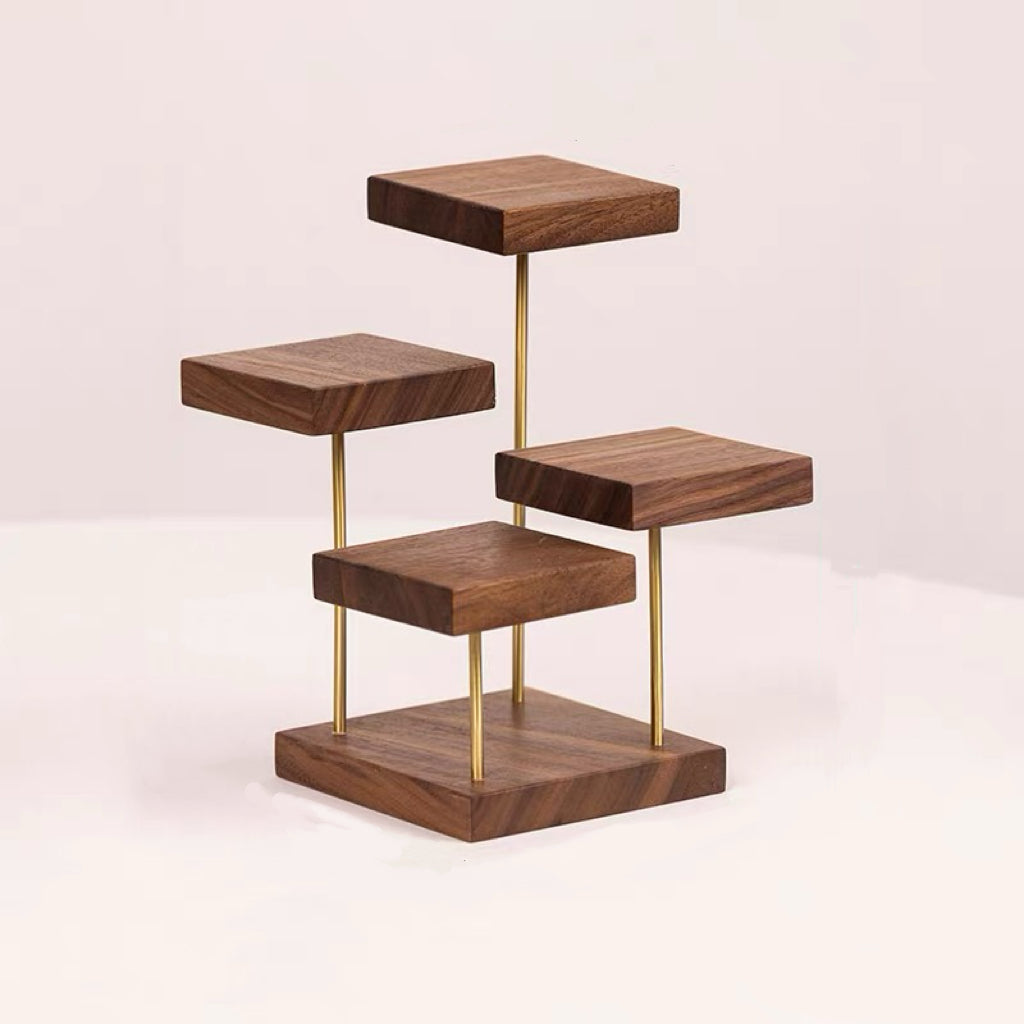 A modern four-tier wooden shelf stand with a dark walnut finish and slim gold metal support rods, shown on a clean off-white background.