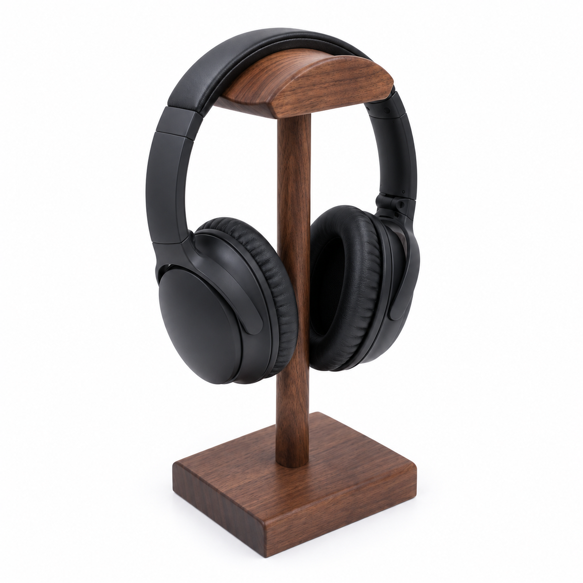 Black over-ear headphones displayed on a wooden stand against a clean white background.