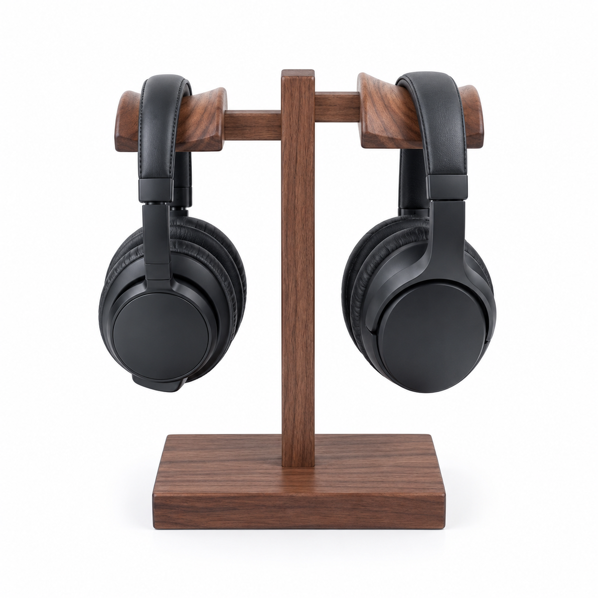 A pair of black over-ear headphones displayed on a wooden stand with a matching wooden base and crossbar, set against a plain white background.