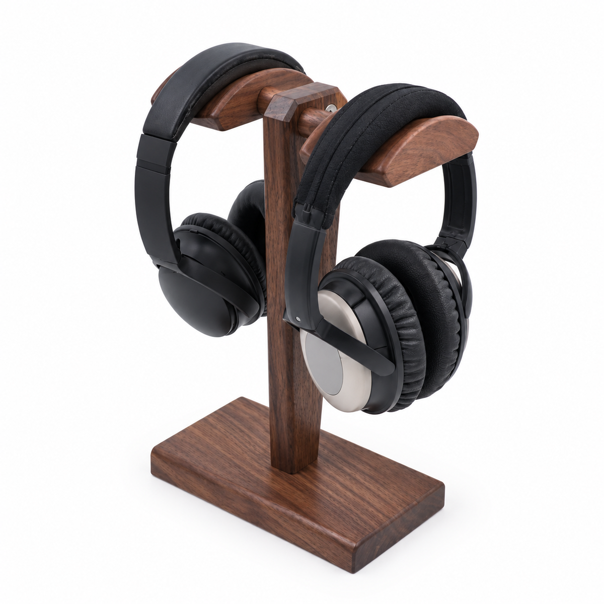 A pair of black over-ear headphones displayed on a wooden stand against a plain white background.