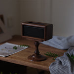 Natural wood speaker riser with smooth walnut grain finish