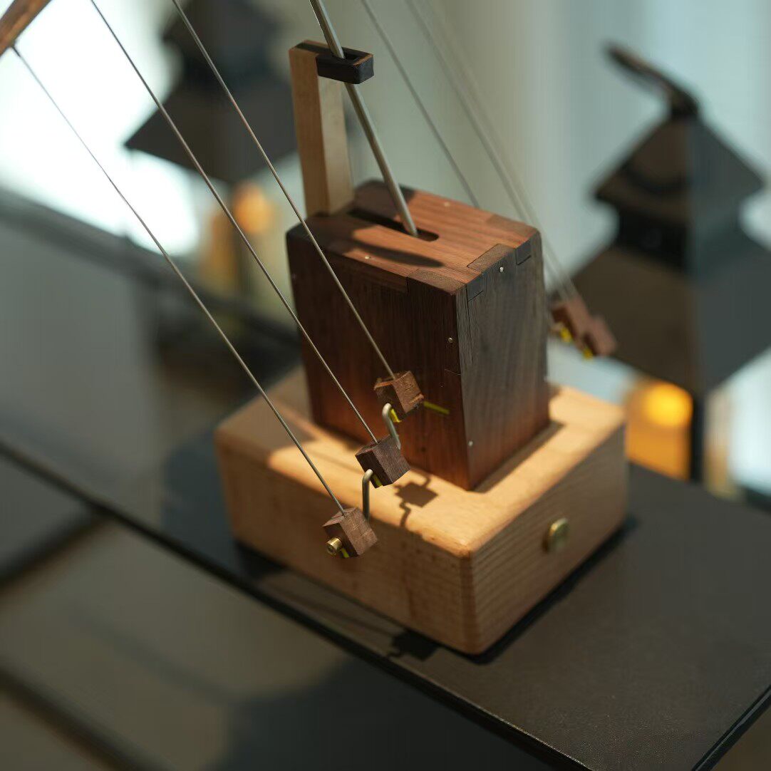 Wooden mechanical model on a reflective surface
